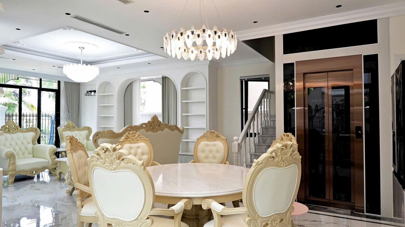 Bronze stainless steel lift door in the living room of a neoclassical villa